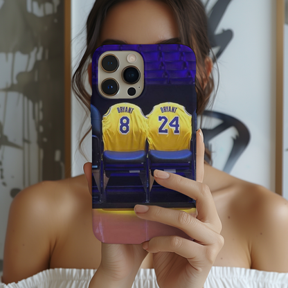 a woman holding up a phone case with two basketball jerseys on it