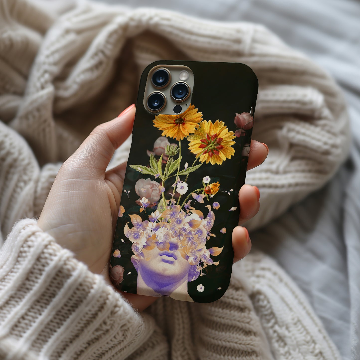 a person holding a phone case with flowers on it